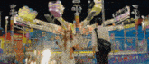 a man and a woman are standing in front of an amusement park ride that says jump on it