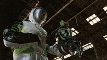 a robot in a green and white suit holds a green object