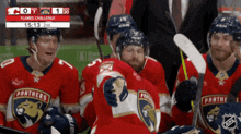 a group of panthers hockey players sit on the bench