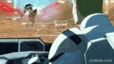a gif from gifrun.com shows a man looking at a robot in a video game
