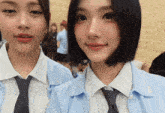 two girls wearing school uniforms and ties pose for a photo