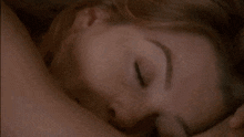 a close up of a woman 's face with her eyes closed and her mouth open