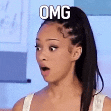 a woman with a surprised look on her face is wearing a white tank top and has the word omg above her head .
