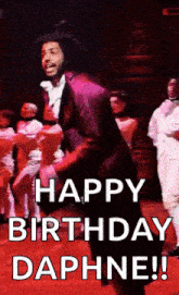 a man is dancing on a stage with the words `` happy birthday daphine '' .