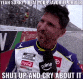 a man wearing a nascar shirt is talking into a microphone with a caption that says shut up and cry about it