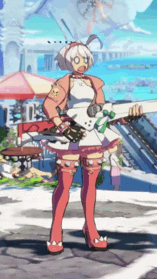 a girl is holding a guitar in front of a beach