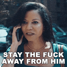 a woman talking on a cell phone with the words " stay the fuck away from him " below her