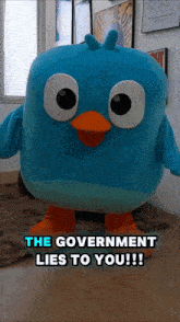 a blue bird mascot with the words " the government lies to you " below it
