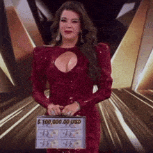 a woman in a red dress is holding a sign that says $ 10,000.00 usd .
