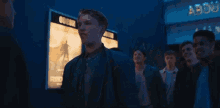 a man is standing in front of a sign that says about film