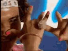 a close up of a woman 's hands with pink nails and a headband that says ' usa ' on it