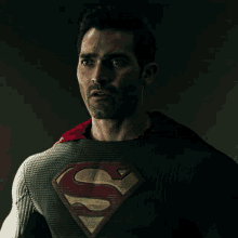 a man in a superman costume has a red cape