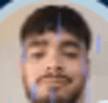 a blurry picture of a man with a beard and closed eyes .