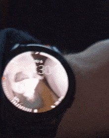a person is wearing a smart watch that says the time is 3:30