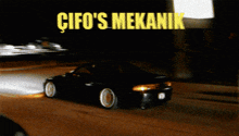a black car is driving down a street with the words cifo 's mekanik written above it