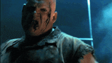 a man with blood coming out of his mouth is standing in a dark room