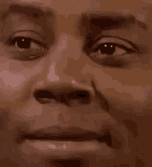 a close up of a man 's face with a serious expression on his face .