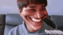 a man is making a funny face with his mouth open .