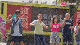 a group of people are posing in front of a sign that says ltn