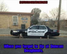 a police car is parked on the side of the road in front of a brick building