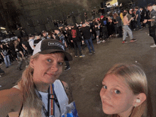 a woman wearing a hat that says fly on it stands next to a young girl