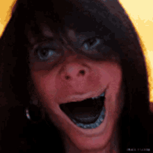 a close up of a woman making a funny face with her mouth open