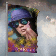 a colorful flag with a picture of a person and the name cakson on it