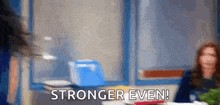 a blurred image of a woman sitting at a table with the words `` stronger even '' written on it .