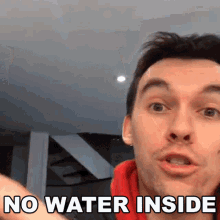 a man says " no water inside " in front of a staircase