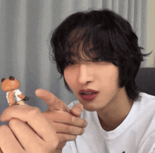 a person holding a stuffed animal in their hand