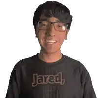 a man wearing glasses and a black shirt that says jared on it