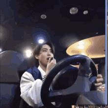 a man is driving a car and applying lipstick to his lips