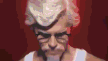 a blurry picture of a man with glasses and a white shirt