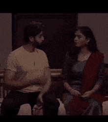a man and a woman are sitting next to each other