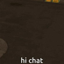 a boy in a blue shirt and red hat is standing in a dark room and says hi chat