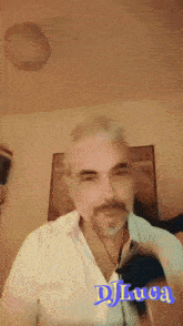 a man wearing a white shirt with the name dj luca on the bottom