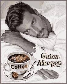 a man is laying in bed next to a cup of coffee