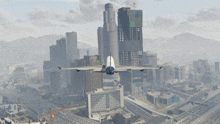 an airplane is flying over a city with a few buildings that have the letter n on them