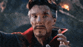 a man with a beard is wearing a red coat