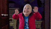 a young boy wearing a red jacket and a blue shirt is laughing with a viggle.ai logo behind him