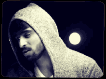 a man with a beard is wearing a hoodie