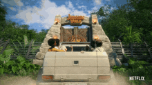 a netflix ad shows a car driving to jurassic world