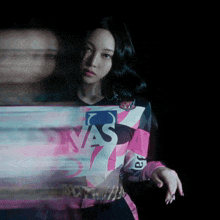 a blurry photo of a woman wearing a shirt that says ' nas ' on it