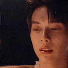 a close up of a young man 's face with a blurred background .