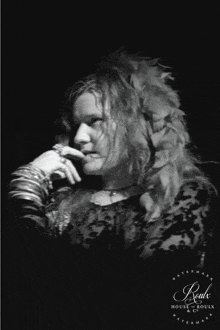 a black and white photo of a woman with feathers in her hair is watermarked by beaut house & souls