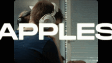 a man wearing headphones with the word apples on the bottom