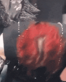 a close up of a person 's face with red hair