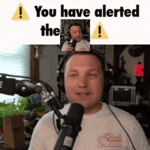 a man wearing headphones stands in front of a microphone with the words you have alerted the above him