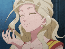 a woman with blonde hair and red nails holds her hand to her face