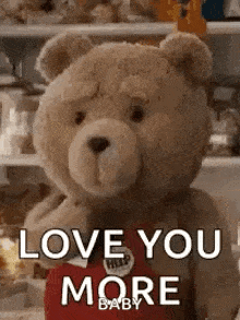 a teddy bear is holding a heart and saying `` love you more baby '' .